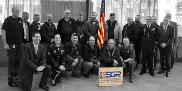 ESRG veterans gather around a U.S. flag.