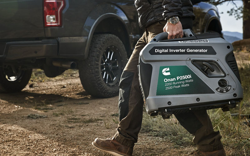 A person carries the cummins portable p2500i generator