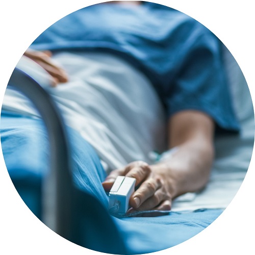 Patient in bed with a heart beat monitor