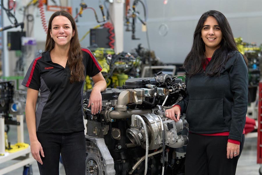 Employees next to engine