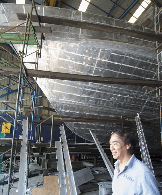 Managing Director Khun Tavipol with the new vessel in the building hall.