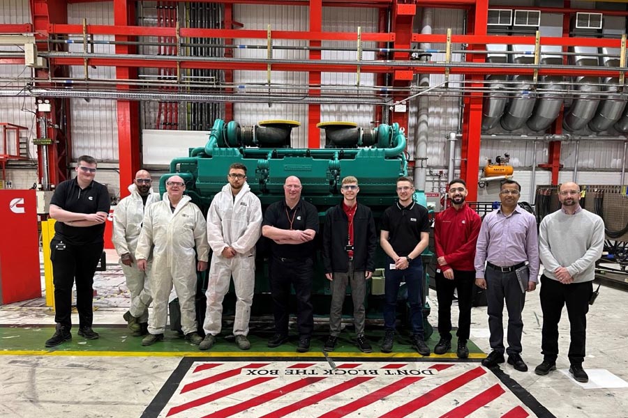 Employees standing by engine