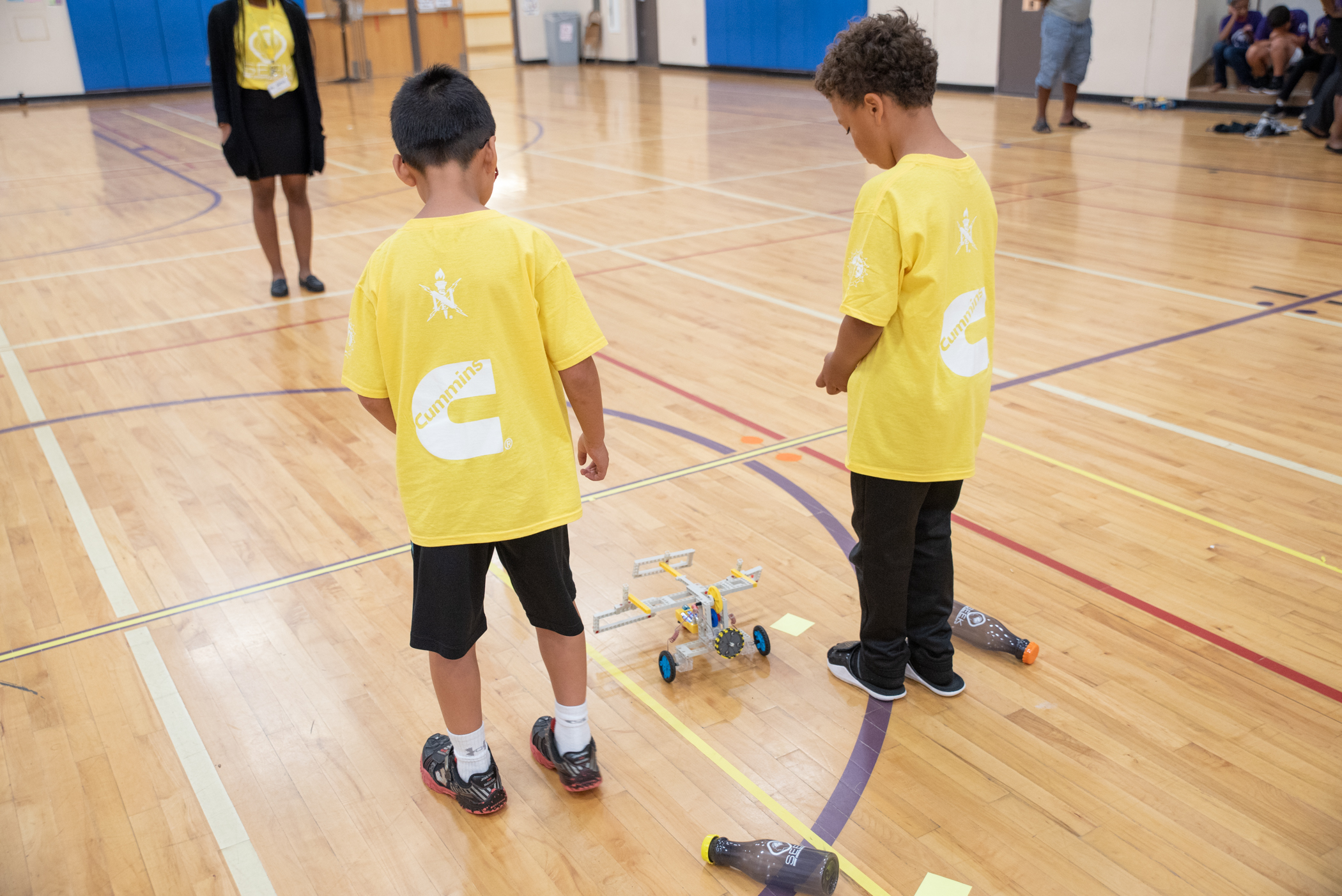 Two SEEK third grade youth begin to send their robot through the obstacle course.