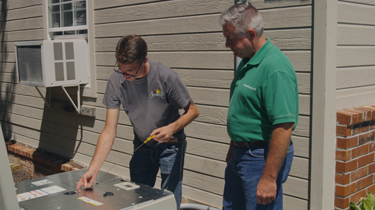 Chad Jester gets tutorial from “The Generator Guy” during the installation of a Cummins QuietConnect home standby generator in Broken Arrow, OK