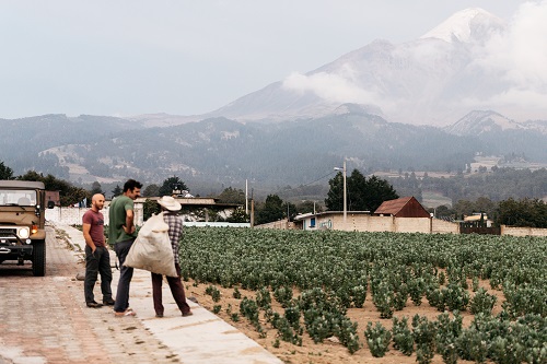 Stuart and Ploog talk to a local resident on their trip with Pico de Orizaba in the background.