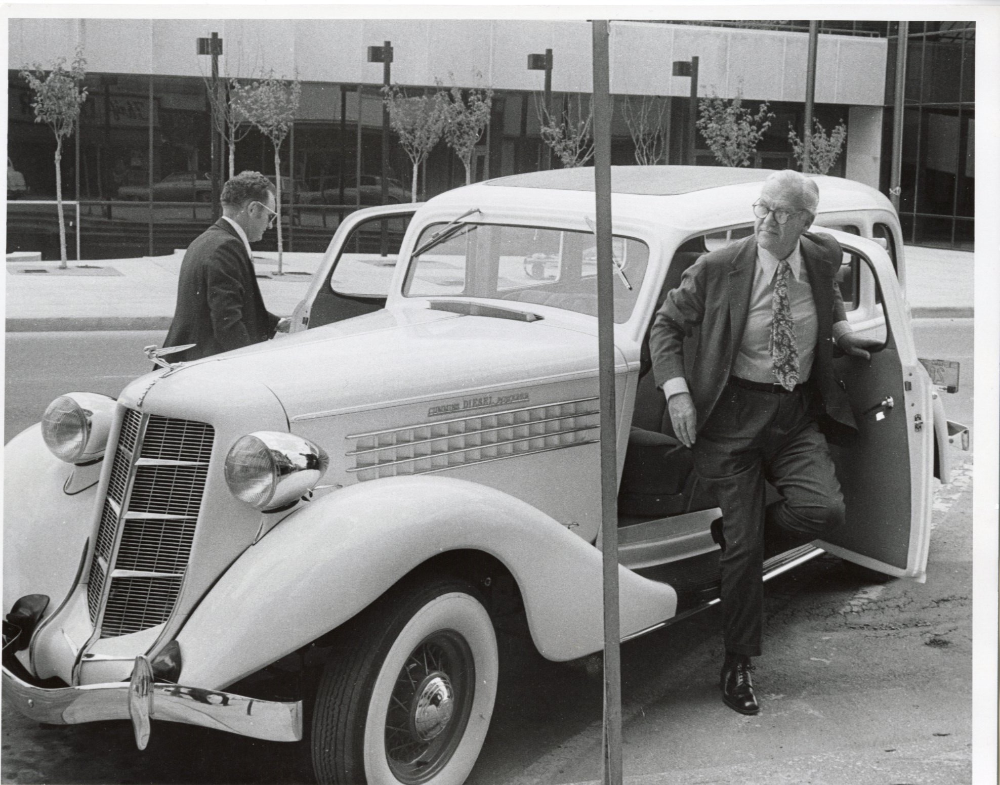 J. I. Miller exits from the restored 1935 Auburn 655 sedan given to him in 1974 as a 40th Anniversary gift.