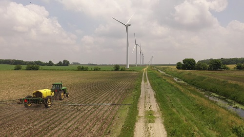 A farmer works near the Meadow Lake Wind Farm expansion