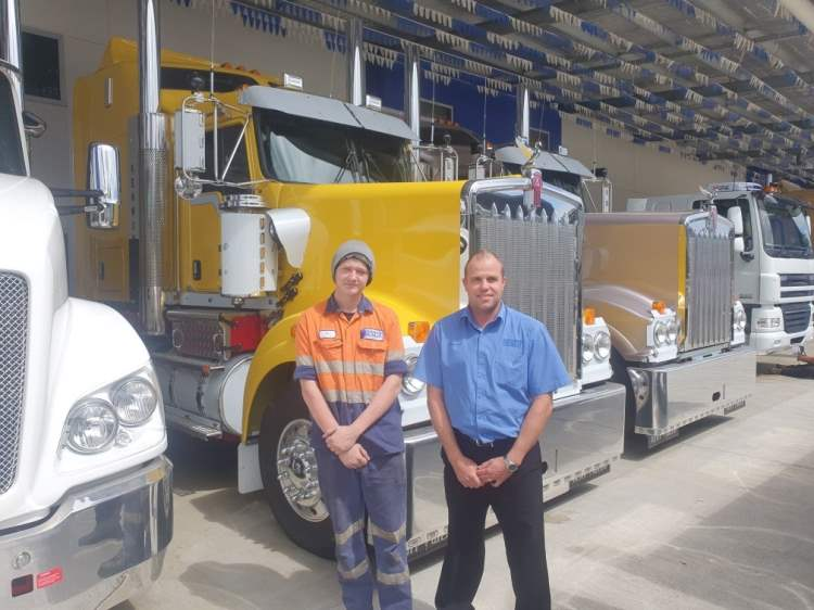 Ty Lynn (left, standing with his manager in front of a recently serviced vehicle) credits Cummins TEC