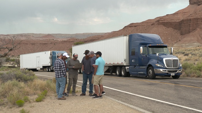 Cummins Engineer Trent Berardi (center, with laptop), talks to X12 team members during a stop in central Utah (U.S.A.) earlier this year.