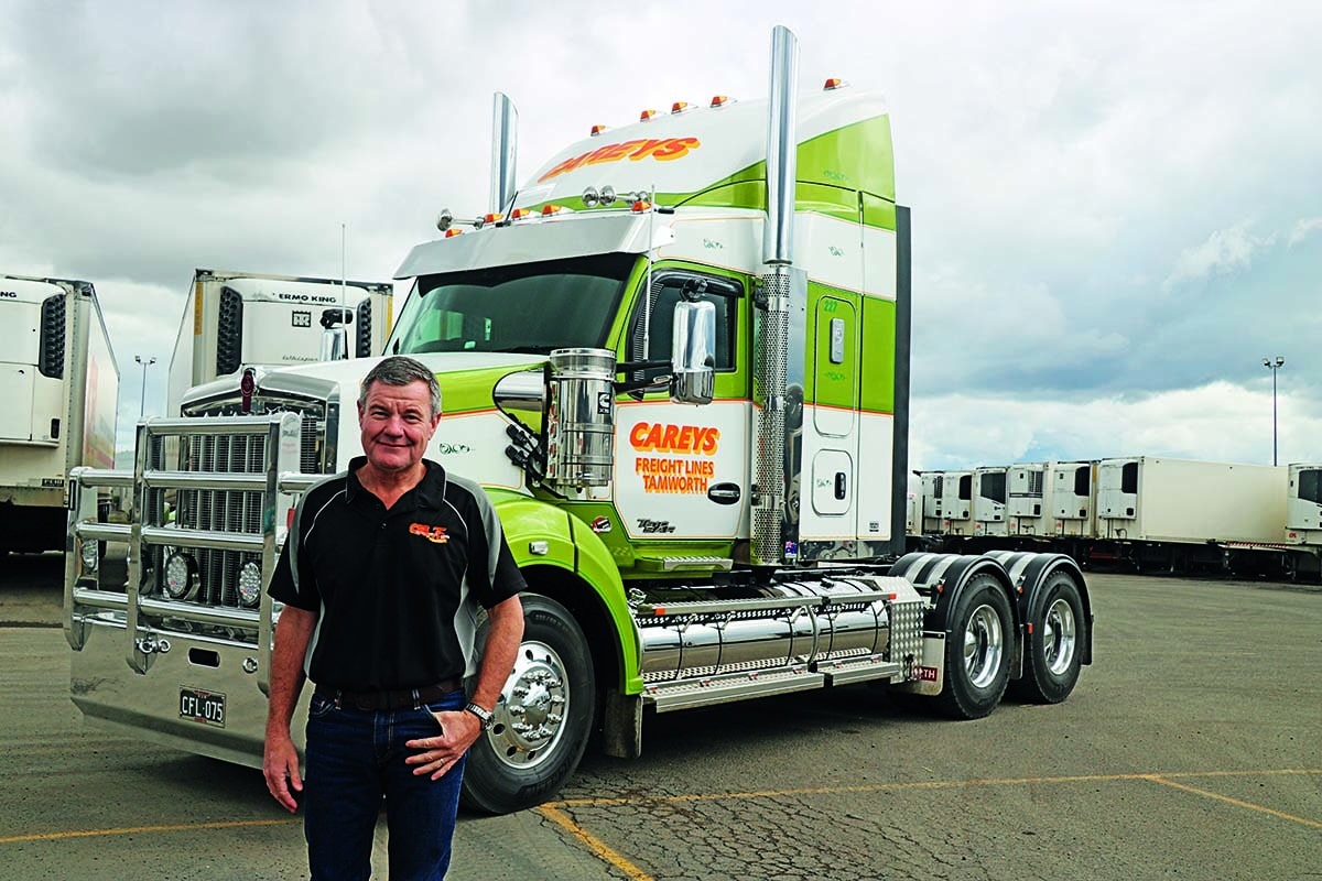 Harold Carey standing in front of semi cab