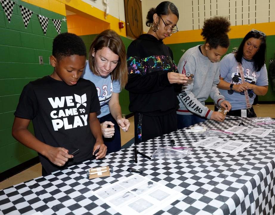 Cummins volunteers helping students build cars