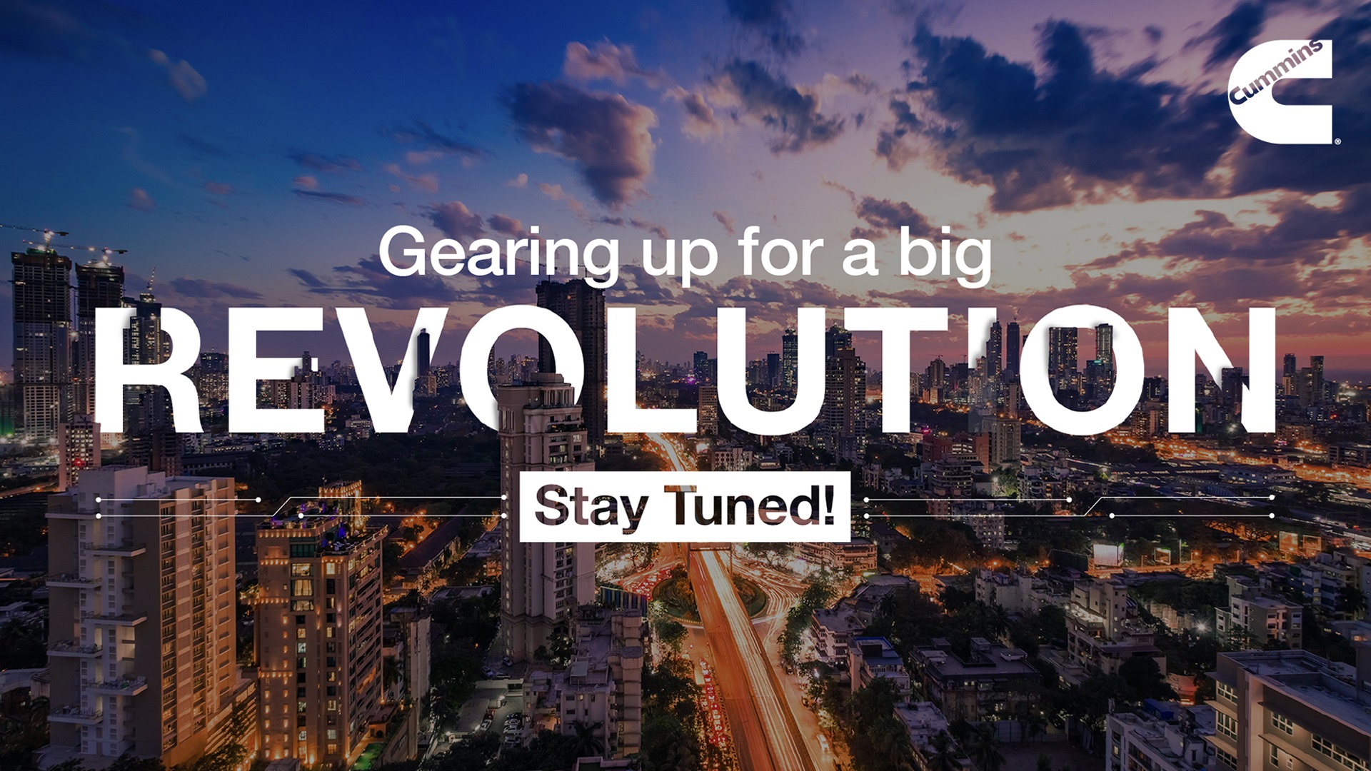 Text on an image of a city skyline says "Gearing up for a big revolution - stay tuned"