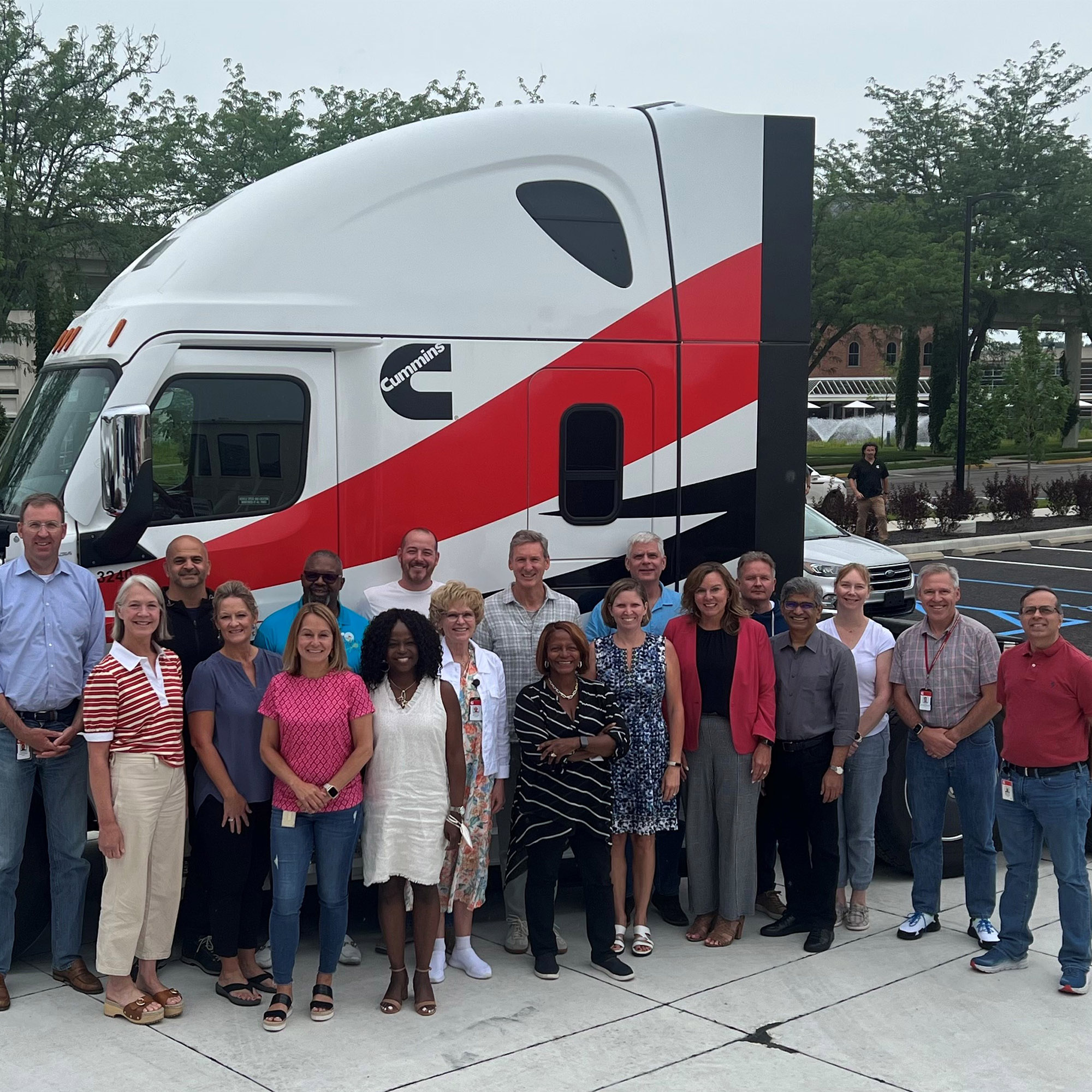 Cummins leadership team smiling in front of truck