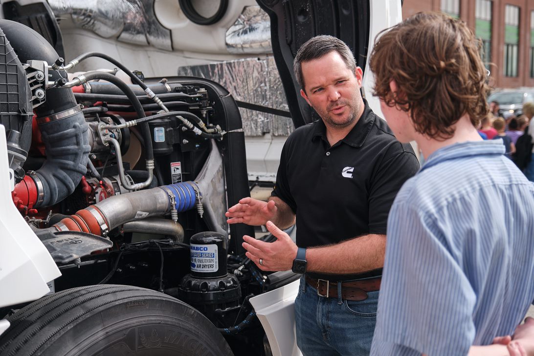 Cummins employee teaching student about Cummins products