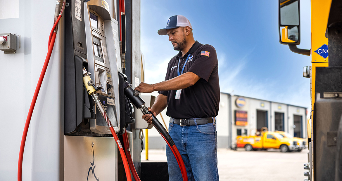 man pumps gas at a Trillium pump at a Love's gas station