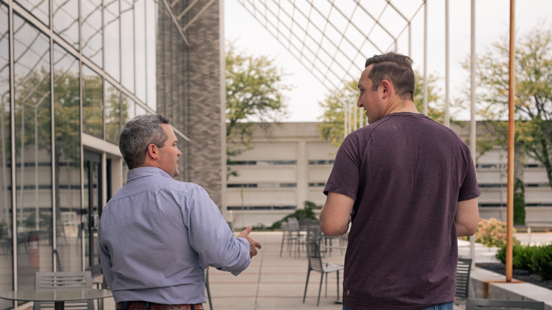 2 men talking while walking