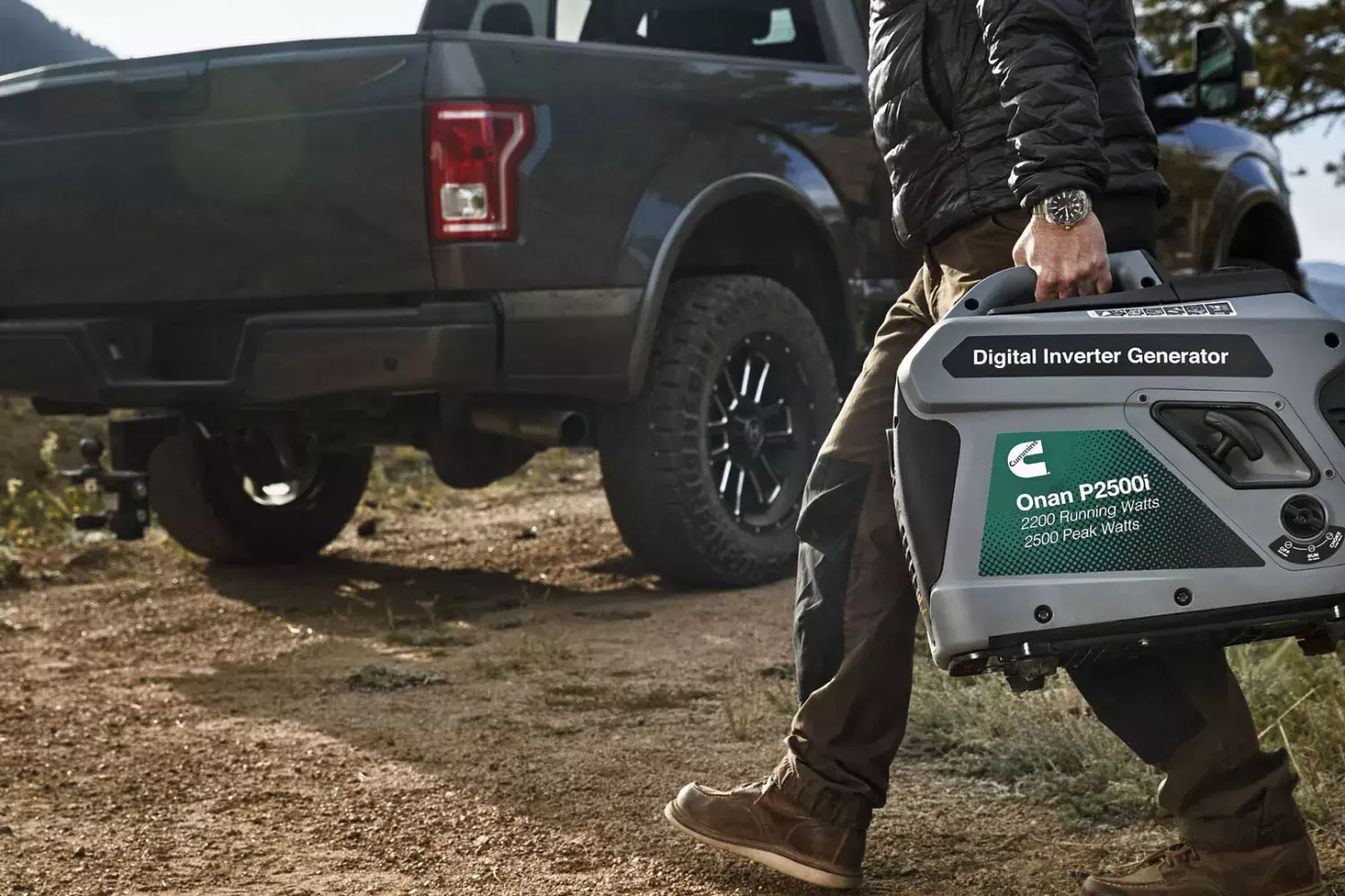 man carrying portable generator to truck outdoors