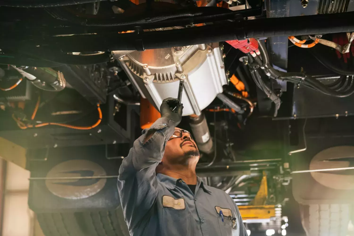 technician working on electric school bus