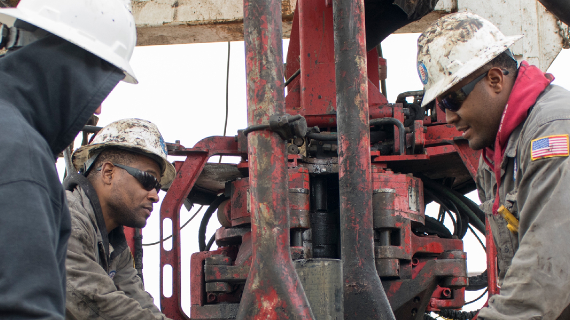 men working a drilling rig