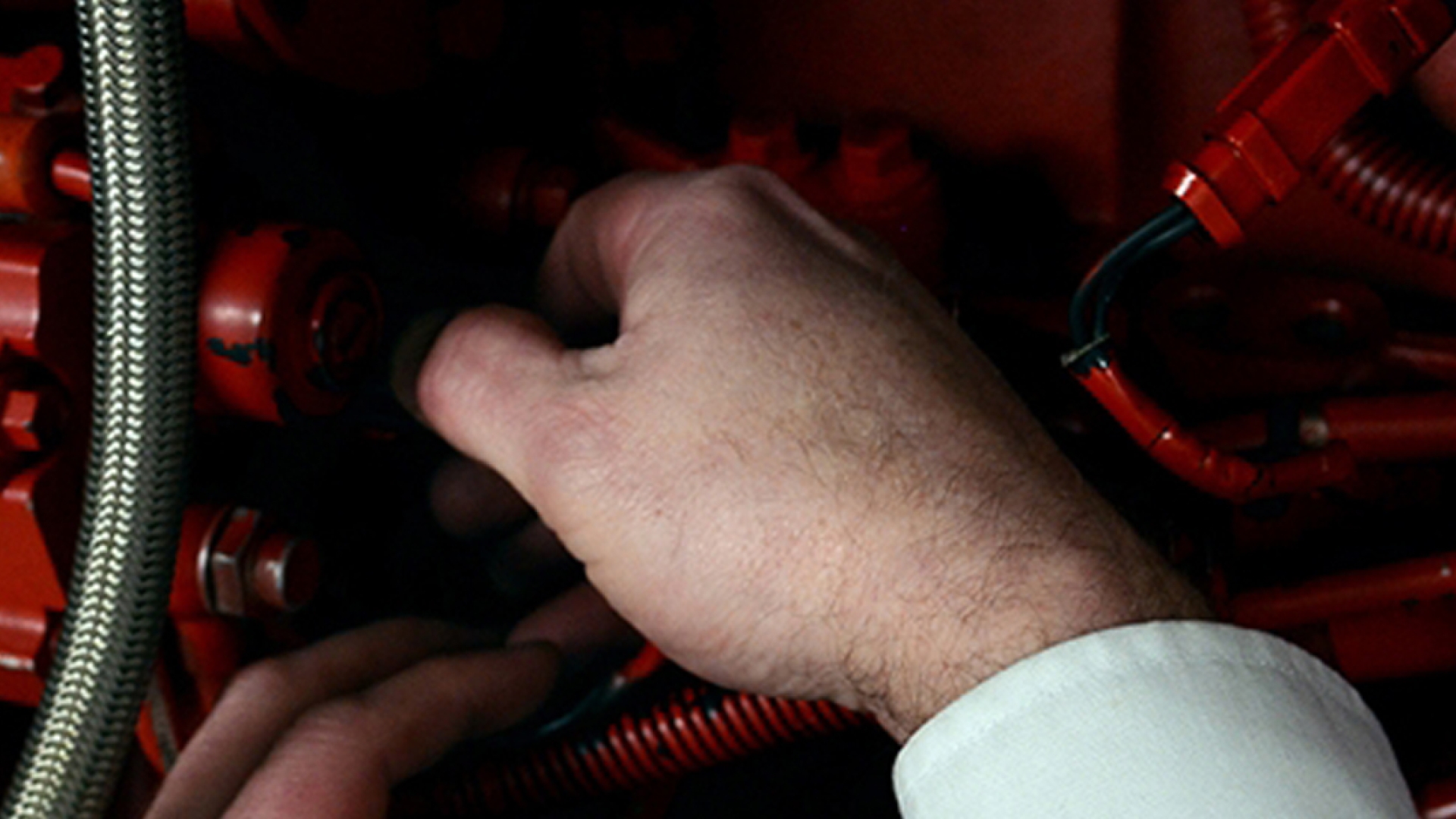 hands working on fire pump drive engine
