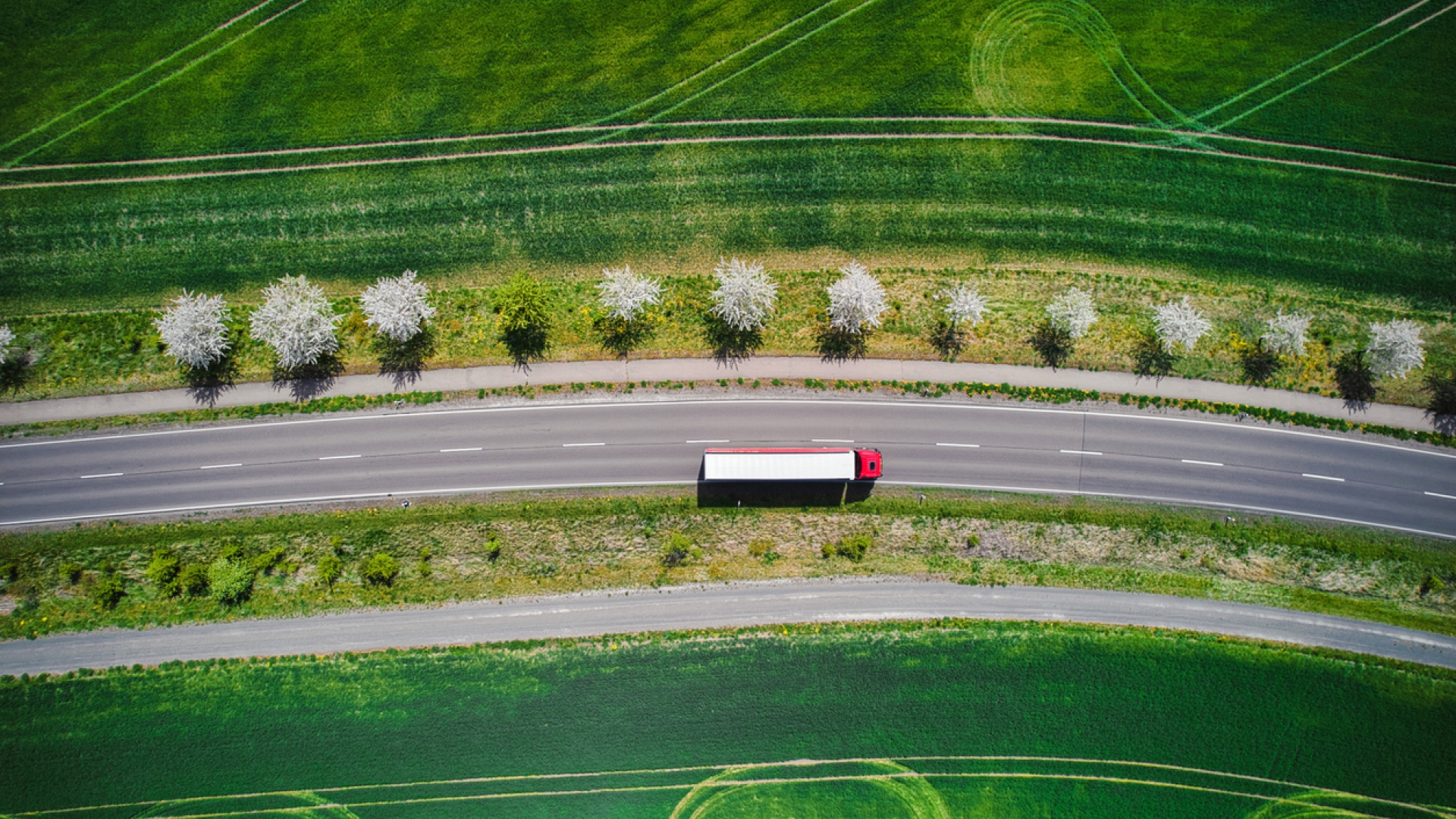 truck on highway next to green field