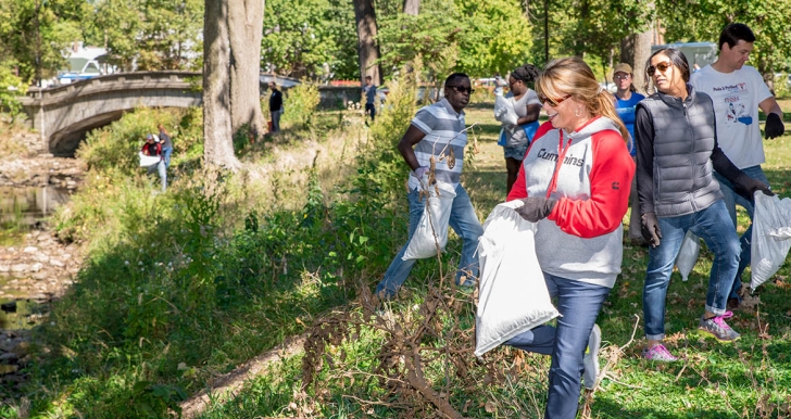 Employees cleaning a park