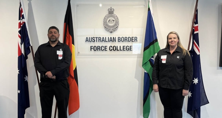 Employees standing by flags