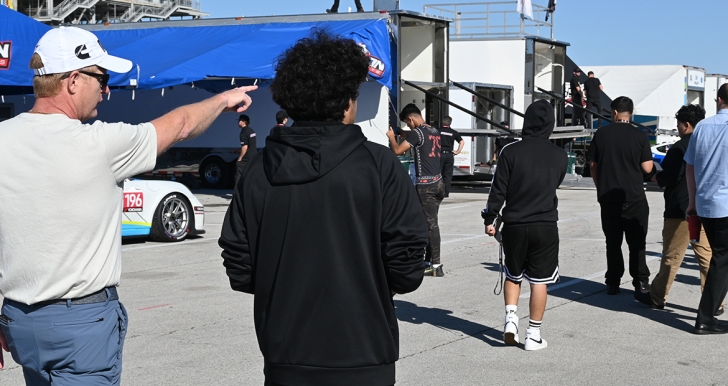 Cummins employee pointing out cars at track