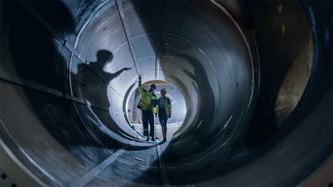 Workers inspecting industrial equipment