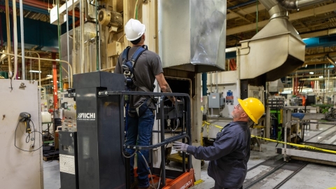 employees with hard hats displaying safety protocol