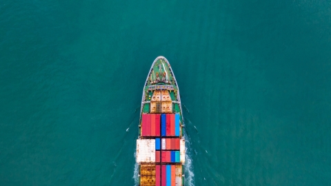 cargo ship moving through a large body of water