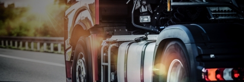 closeup shot of the wheels of a semi truck as it drives on a highway