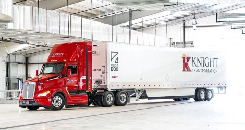 red and white Knight Transportation semi parked in an industrial garage