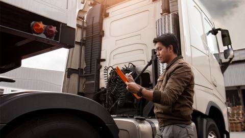 Worker preforming an assessment on a truck