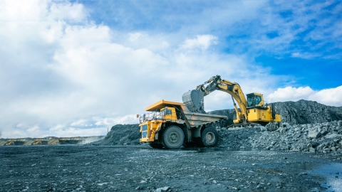 Digger and dump truck on mining site