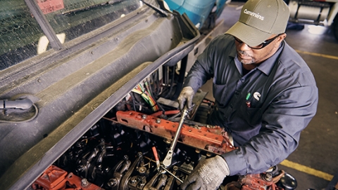 Mechanic changing oil in an engine