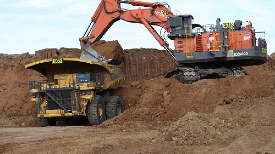 Excavator loading a dump truck