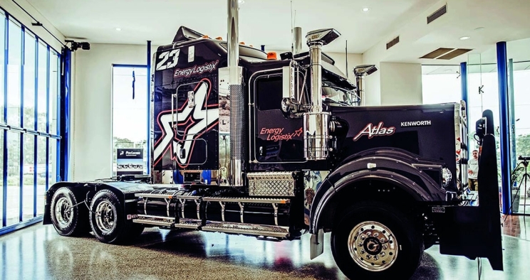 black semi cab on display in a garage