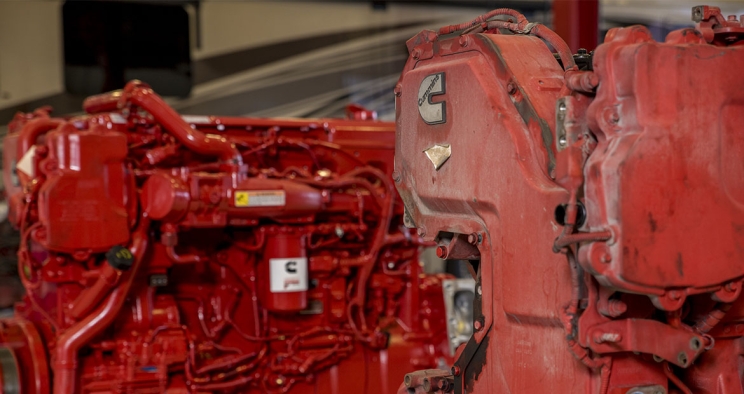 2 red Cummins engines side-by-side, one before and one after remanufacturing