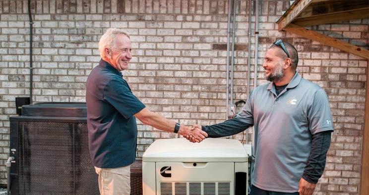 Dealer shaking hands with customer