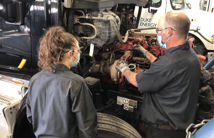 Annika "Niki" Rasband gets instruction from a Cummins technician