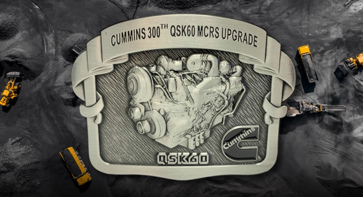 belt buckle with text reading "Cummins 300th QSK60 MCRS Upgrade"
