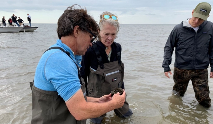 The Nature Conservancy’s Seth Blitch discusses the oyster reef project with Mary Chandler, Vice President – Community Relations and Corporate Responsibility, and Zach Gillen, General Manager -- Sales & Service North America.