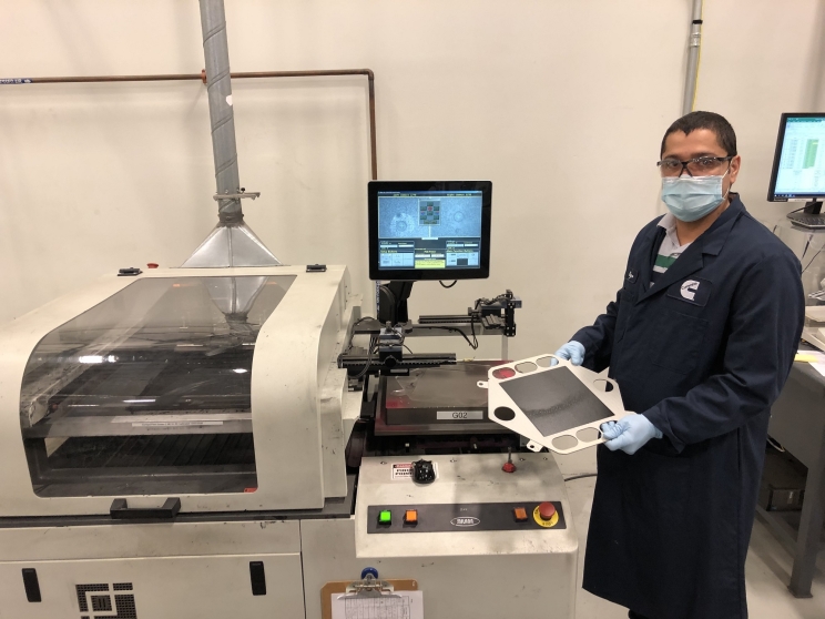 A Cummins employee works on the cathode screen printing process, towards the end of the solid oxide fuel cell manufacturing line at the company's facility in Malta, New York (U.S.).