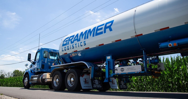 white semi with blue Grammer logo