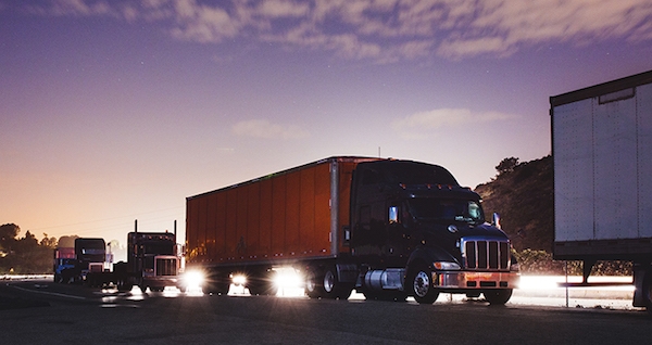 heavy duty truck fleet at sunrise