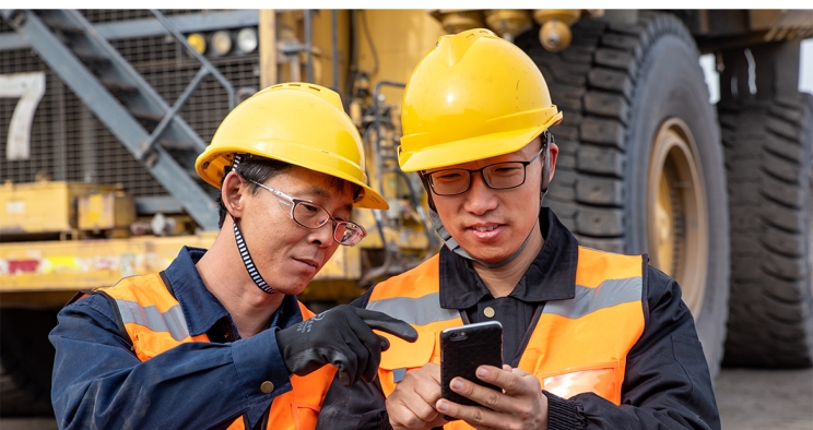 Two employees looking at phone