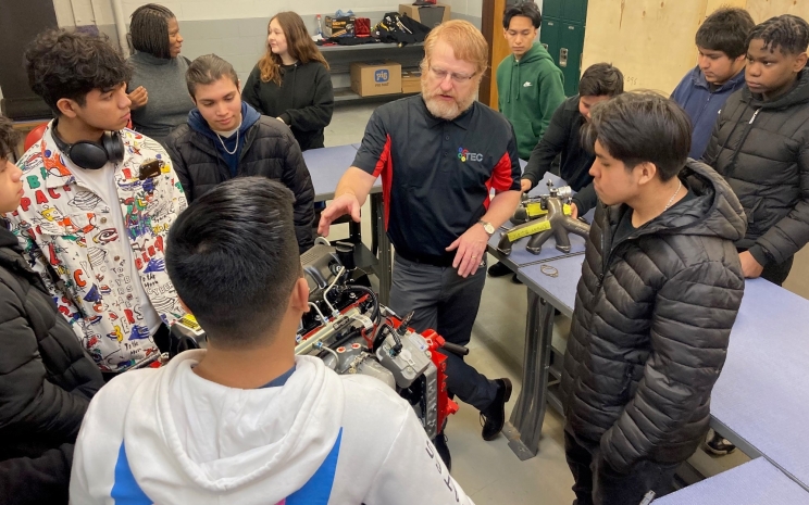 Cummins TEC Director, Jason Irvin describes compontes of a Cummins engine to students looking to sign up for the new Cummins TEC program at Arsenal Technical High School in Indianapolis (U.S.)