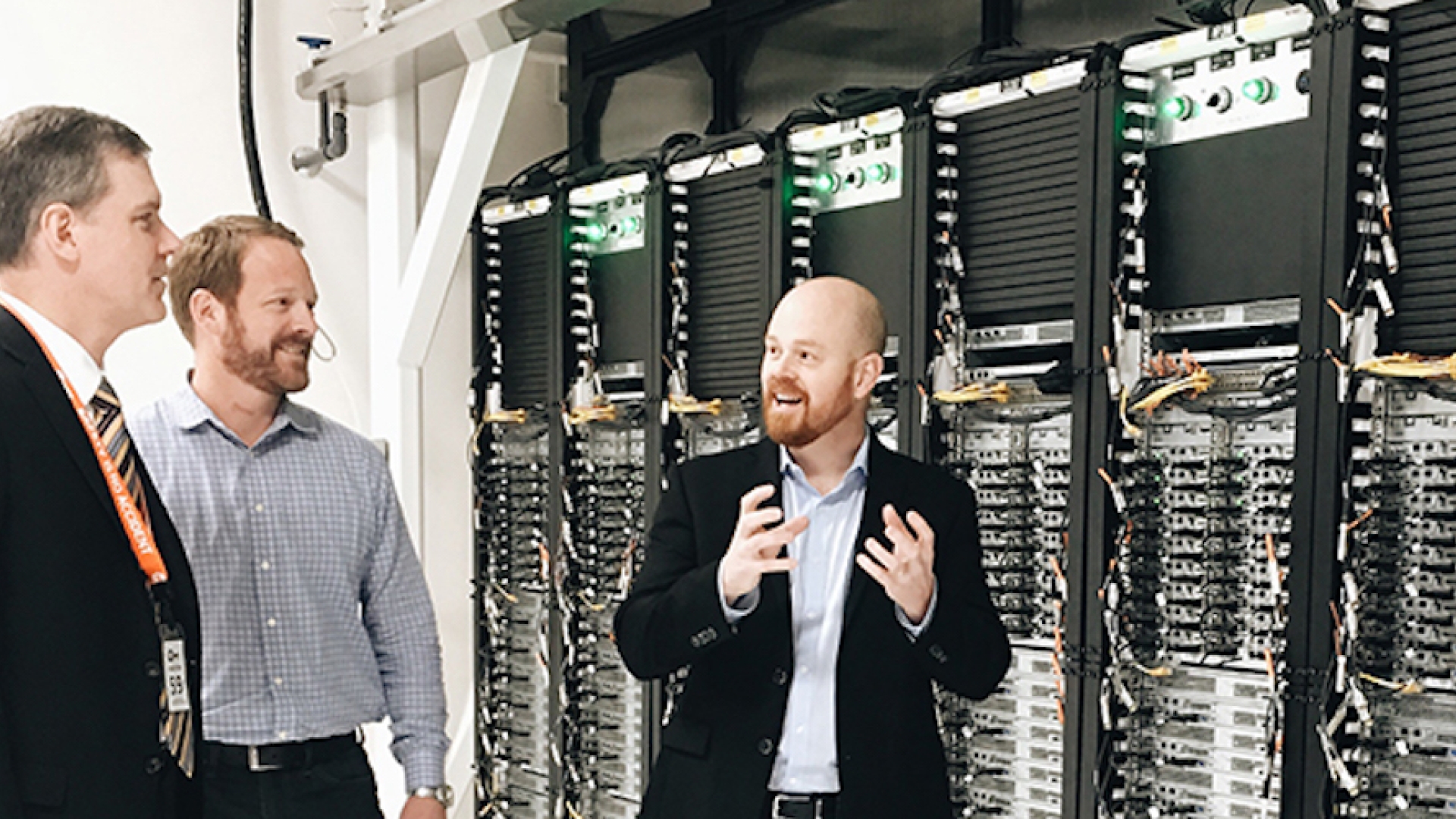 Cummins’ Executive Director of Power Systems Engineering Gary Johansen (left) tours the Advanced Energy Lab with Sean James (center) of Microsoft and Dan Ronco (right) of McKinstry.