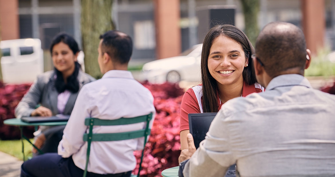 Employees engaging in friendly discussion outside